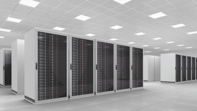 Modern data center with rows of black server racks and bright overhead lighting